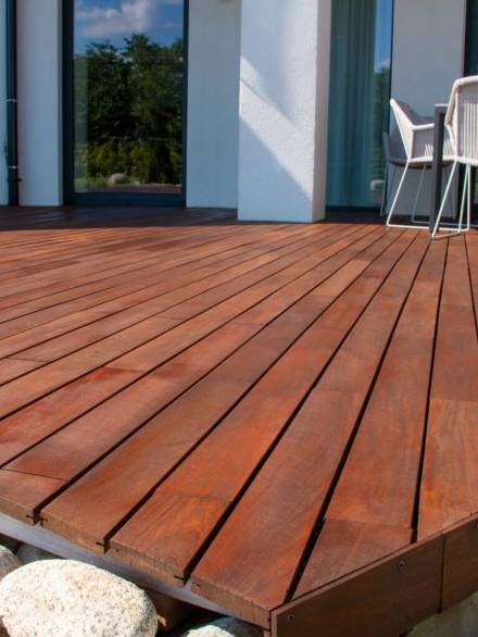 Wood deck, modern house design with wooden patio, low angle view of tropical hardwood decking